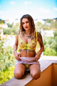 Seline undressing on the balcony
