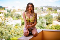 Seline undressing on the balcony